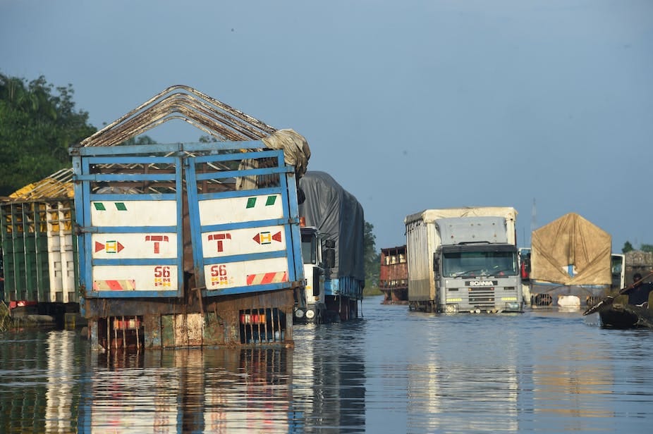 Trucks on a flooded road Trucks on a flooded road