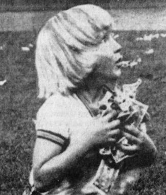 Photos of two participants from Cleveland's money scramble, holding their loot.