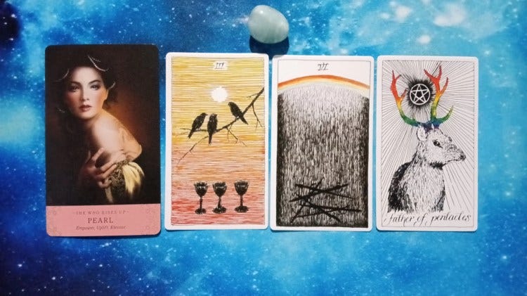 Elle Qui and Wild Unknown Tarot cards with blue stone on starry blue background