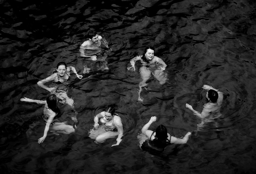 A group of people swimming in a body of water