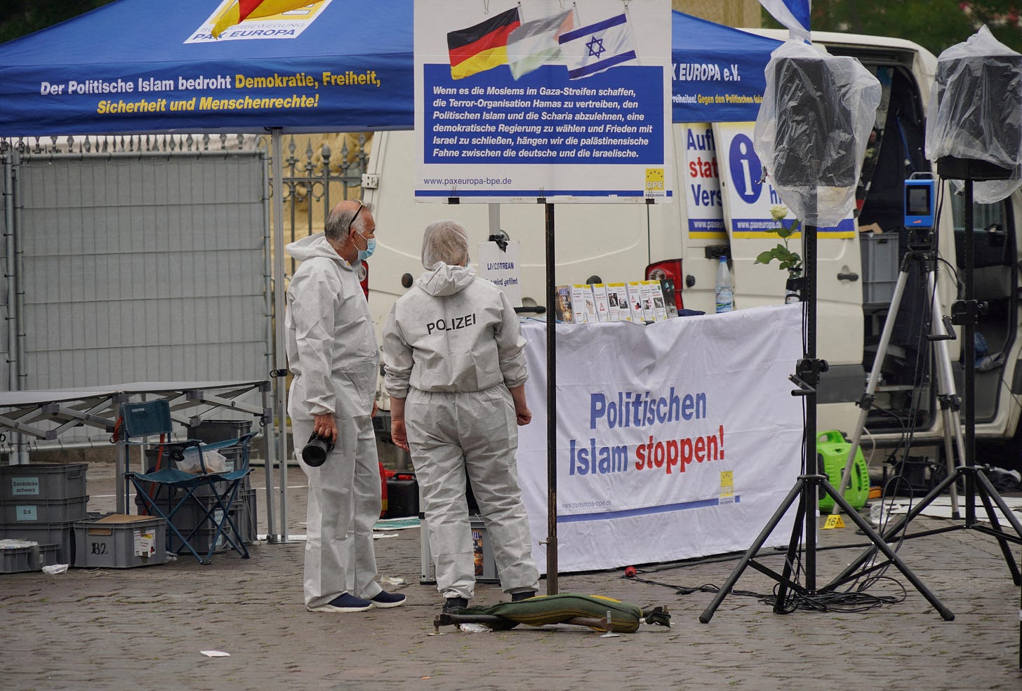 Police investigators work at the scene where a man attacked people at a far right-wing information stand of the Buergerbewegung Pax Europa in Mannheim Police investigators work at the scene where a man attacked people at a far right-wing information stand of the Buergerbewegung Pax Europa in Mannheim