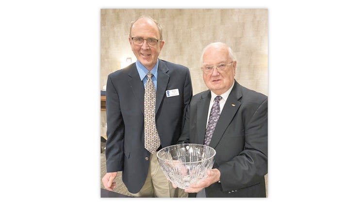 On May 28, Michael Ley, left, president of the American Association of Philatelic Exhibitors, presented the George Brett Cup to Allen D. "Don” Jones, right.