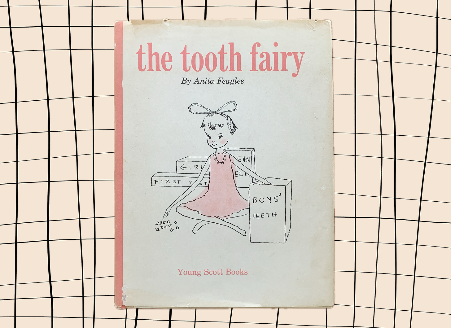 The worn front cover of Anita Feagles' 1962 "The Tooth Fairy." A tooth fairy sits cross-legged on the ground with teeth and boxes of teeth around her. The illustration is done with black hand-drawn lines and pink watercolor. The worn front cover of Anita Feagles' 1962 "The Tooth Fairy." A tooth fairy sits cross-legged on the ground with teeth and boxes of teeth around her. The illustration is done with black hand-drawn lines and pink watercolor.