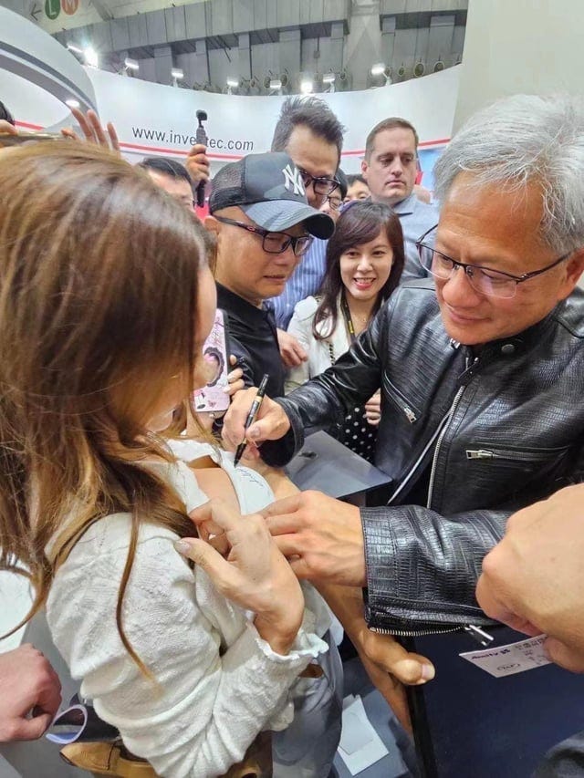 NVIDIA President/CEO Jensen Huang signing a shirt at ... NVIDIA President/CEO Jensen Huang signing a shirt at ...