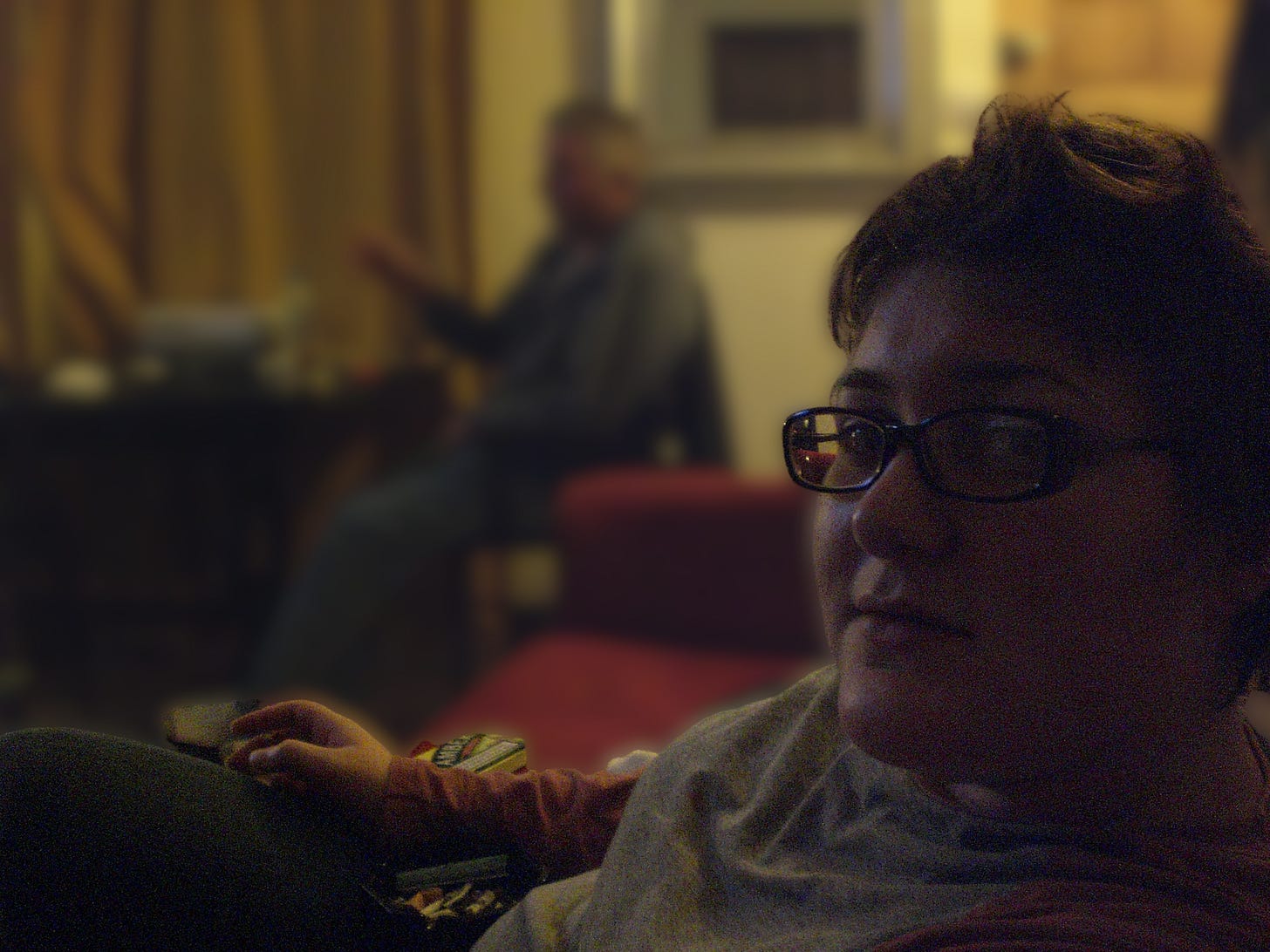 Foreground, sour-faced woman in a t-shirt with blurred background. Foreground, sour-faced woman in a t-shirt with blurred background.