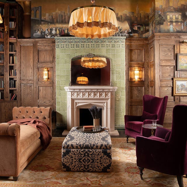 a living room area with firaplce chaise lounge and two purple lounge chairs