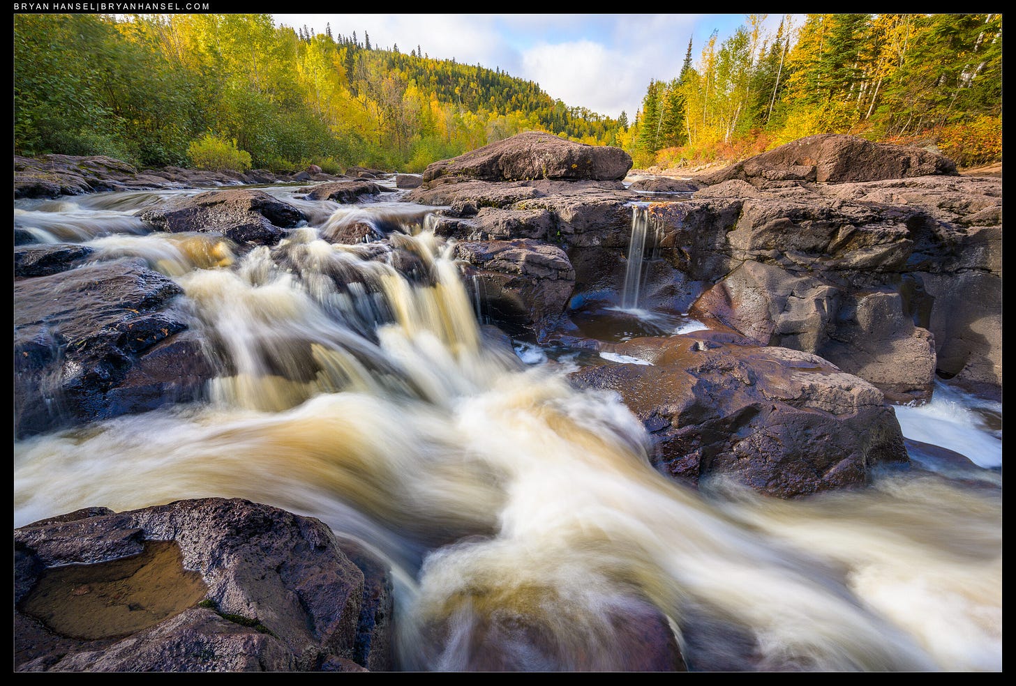 A waterfall surrounded by fall color