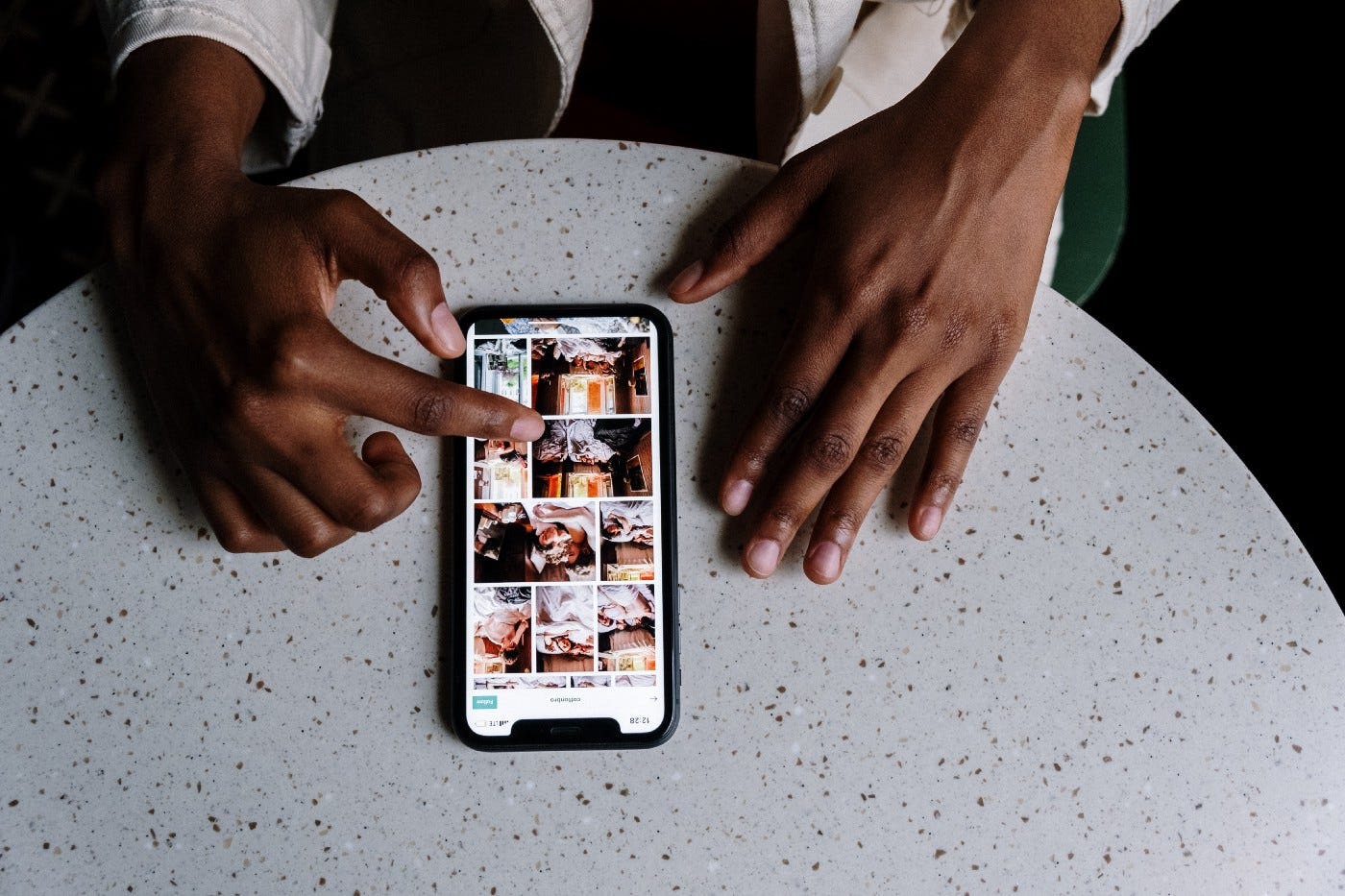 Black man is browsing a feed on his smartphone screen
