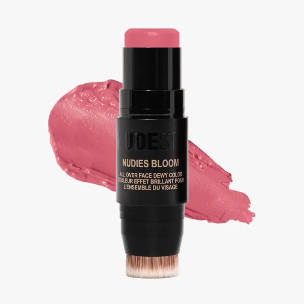 The dual-ended Nudestix Nudies Bloom stick in Cherry Blossom, featuring the radiant cream blush on one end and the built-in flat buffing brush on the other for easy blending. The dual-ended Nudestix Nudies Bloom stick in Cherry Blossom, featuring the radiant cream blush on one end and the built-in flat buffing brush on the other for easy blending.