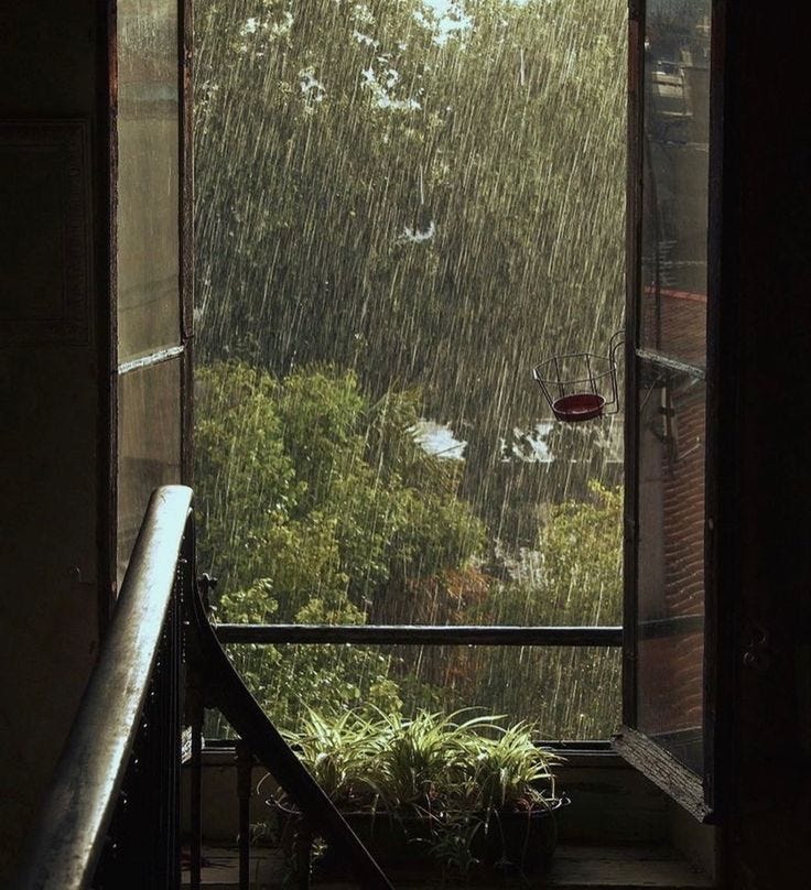 This may contain: an open window with rain falling down on it
