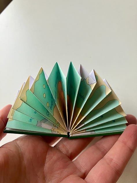 three photographs of the Micro Library Book Fathoms, a miniature book with a dark green cover, with abstract pale yellow and green/blue illustrations.
