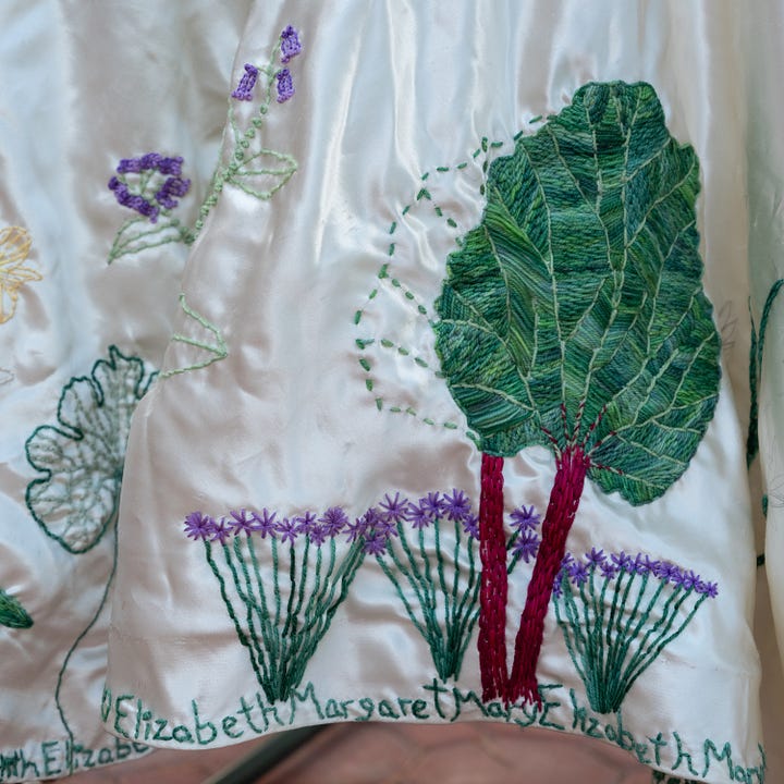 Diptych: Left - embroidered green rhubarb leaf with bright red stems and with green chives stems below, each with an embroidered flower; Right - -Lush green garden scene with lots of green leaves and small purple flowers on different plants.