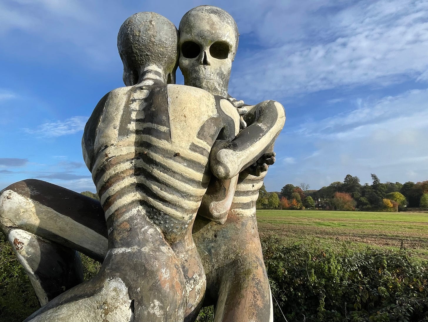 Two fibreglass figures embrace in a field in Checkendon Two fibreglass figures embrace in a field in Checkendon