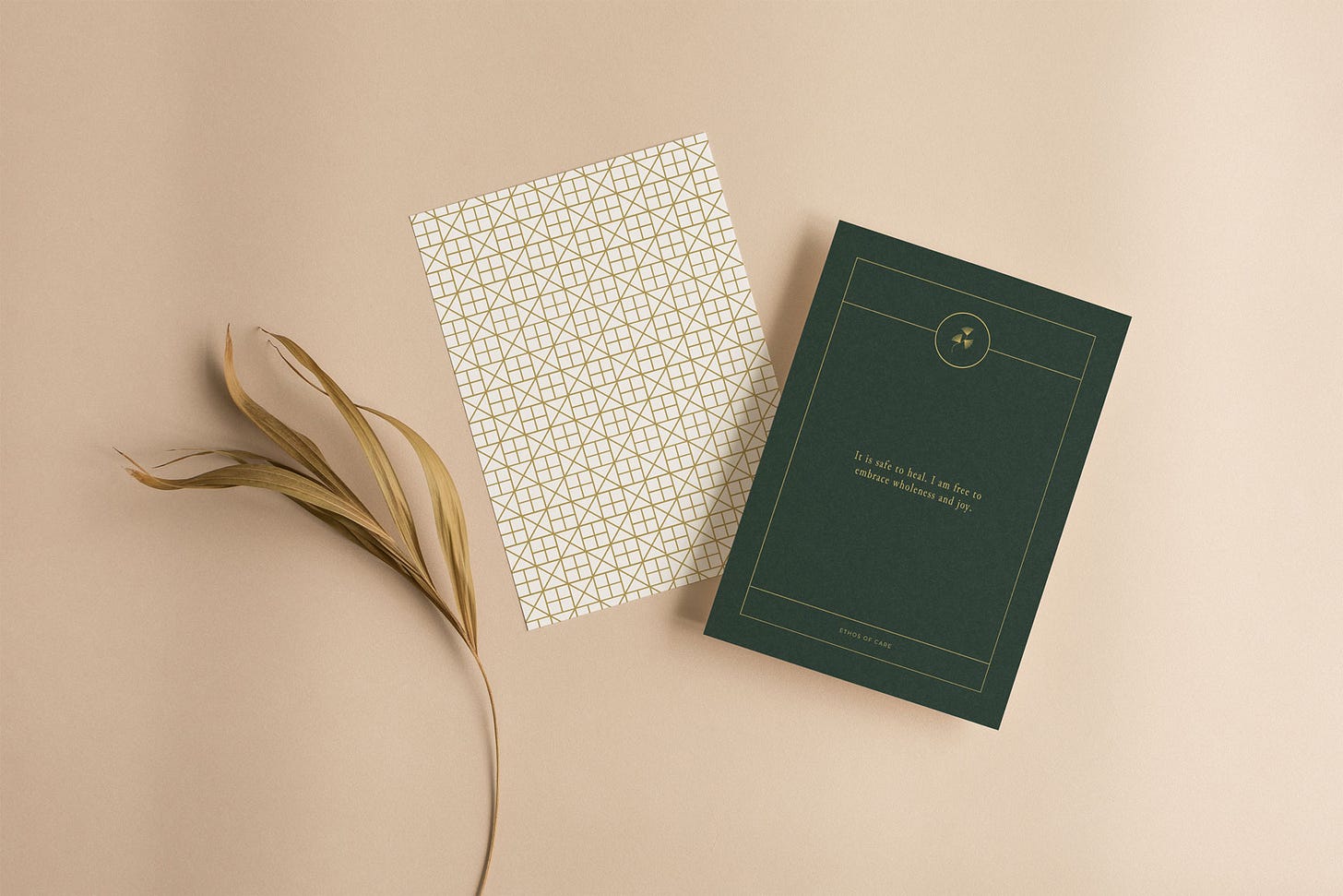 Two cards on beige background next to dried floral. Card one of a geometric pattern. Card two with text that reads: It is safe to heal. I am free to embrace wholeness and joy.