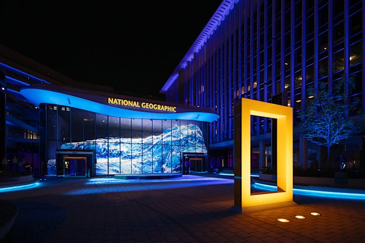 Ocean wave projected on exterior of National Geographic Museum of Exploration during the Wonders of Our World: Ocean nighttime show