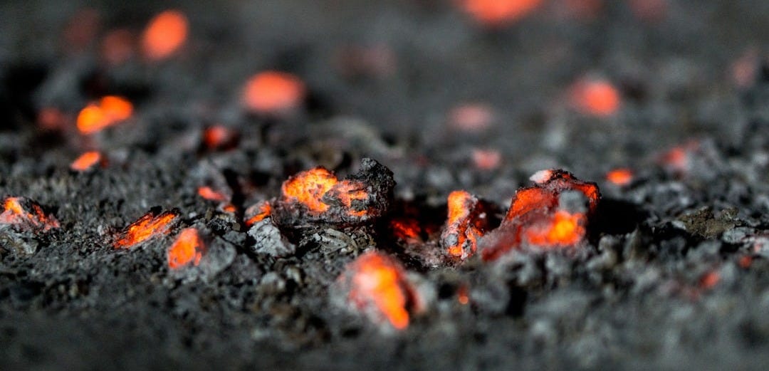 a close up of lava rocks with red lights