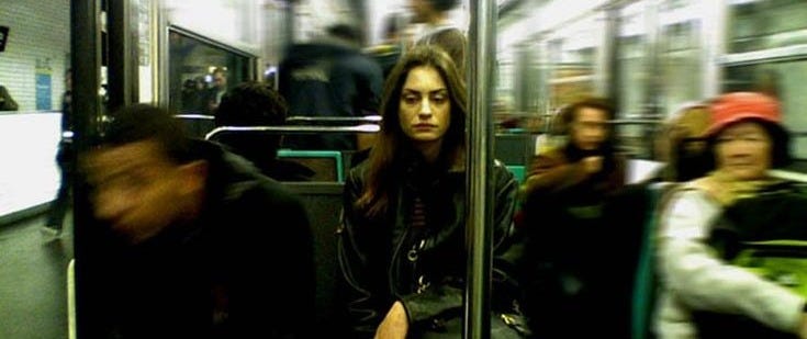 This may contain: a group of people riding on a subway train