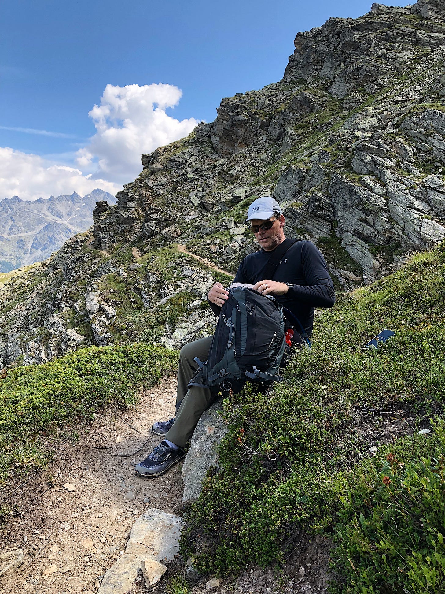 Chris did that whole trail in Switzerland with his right arm in a sling. This is him stopping to take his meds right before the scary bit, which you can see behind him. That Swiss trail was WAAAY scarier than anything we saw in Nepal!