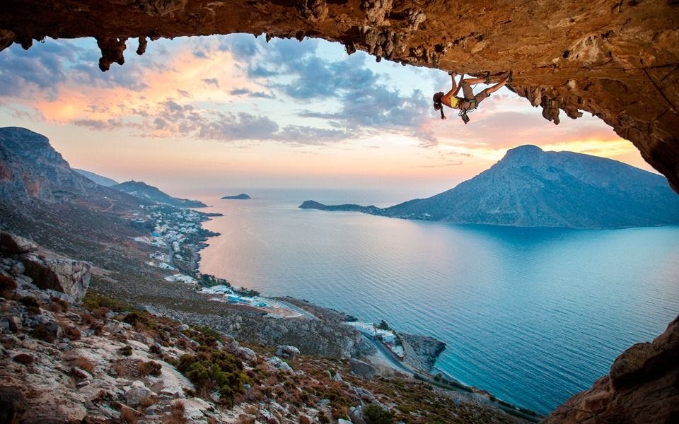 A climber ascending a limestone cliff on the Greek island of Kalymnos, overlooking the Aegean Sea. A climber ascending a limestone cliff on the Greek island of Kalymnos, overlooking the Aegean Sea.