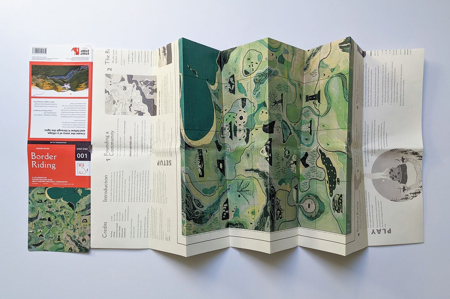 Photo. A richly illustrated game, printed and displayed like a foldable hiker's map.