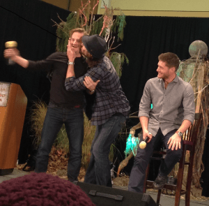 Smack! Jared plants one on Richard while Jensen looks on