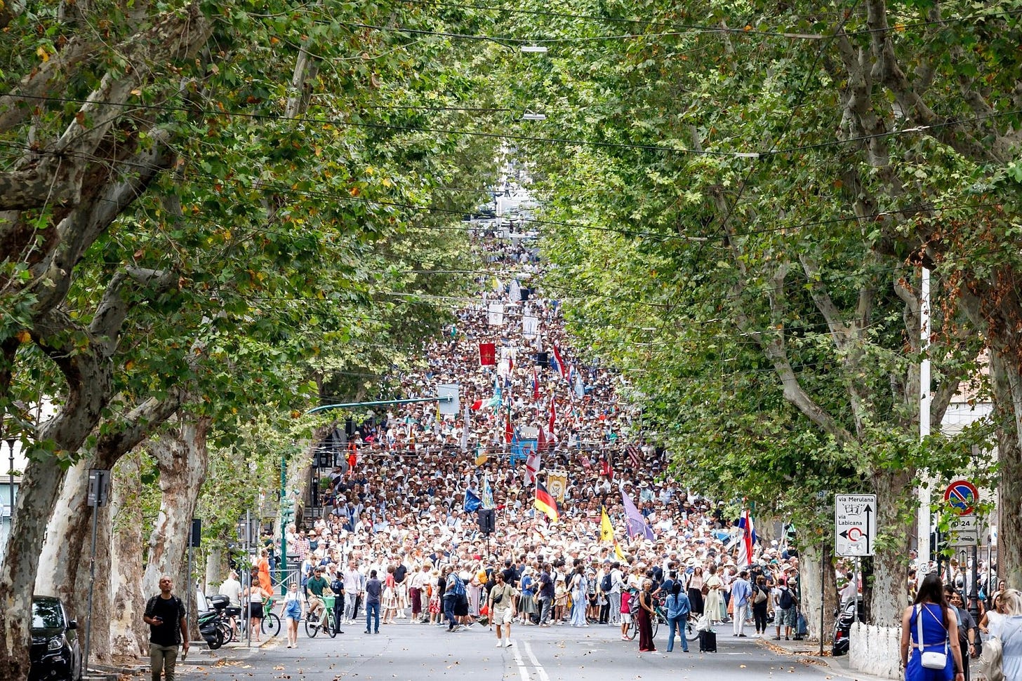 May be an image of 3 people, crowd and road