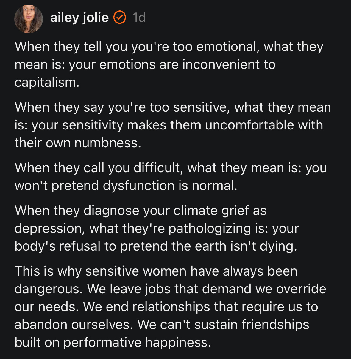 A screenshot of a social media post from a profile labeled “ailey jolie,” featuring a long text message on a black background. The text discusses how emotions, sensitivity, and climate grief are often dismissed or pathologized, and argues that sensitive women are seen as dangerous because they refuse unhealthy expectations.
