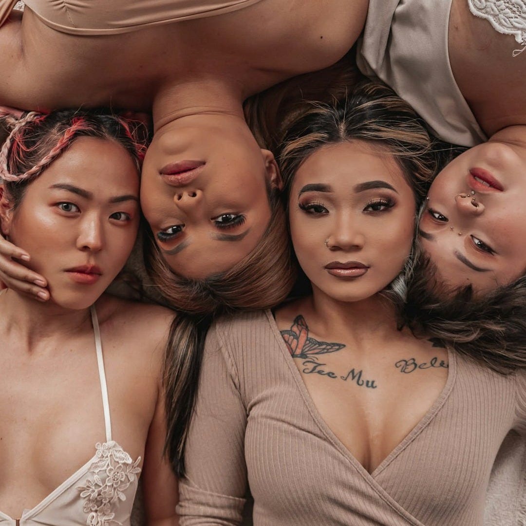 a group of women laying on top of each other a group of women laying on top of each other