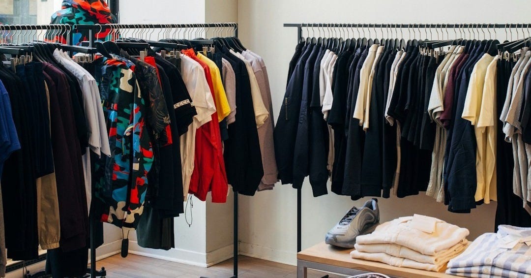 assorted-color clothes hanging on metal racks