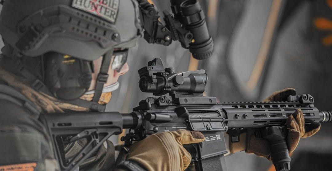 close-up photography of person holding rifle close-up photography of person holding rifle