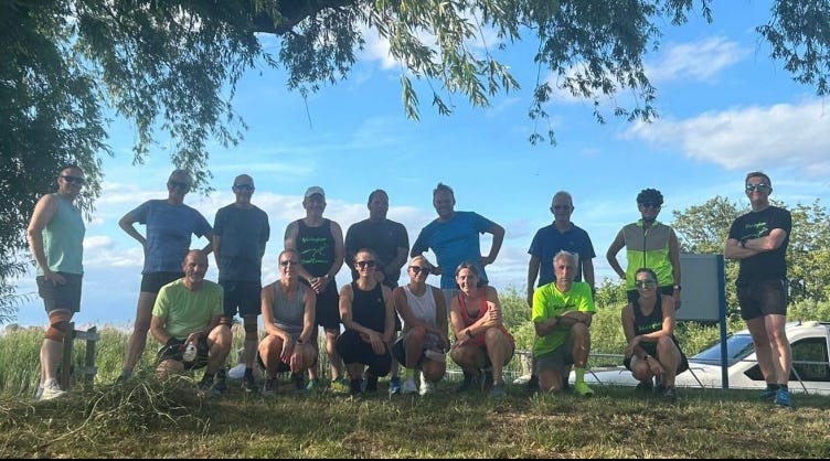 group of runners gathered by the river