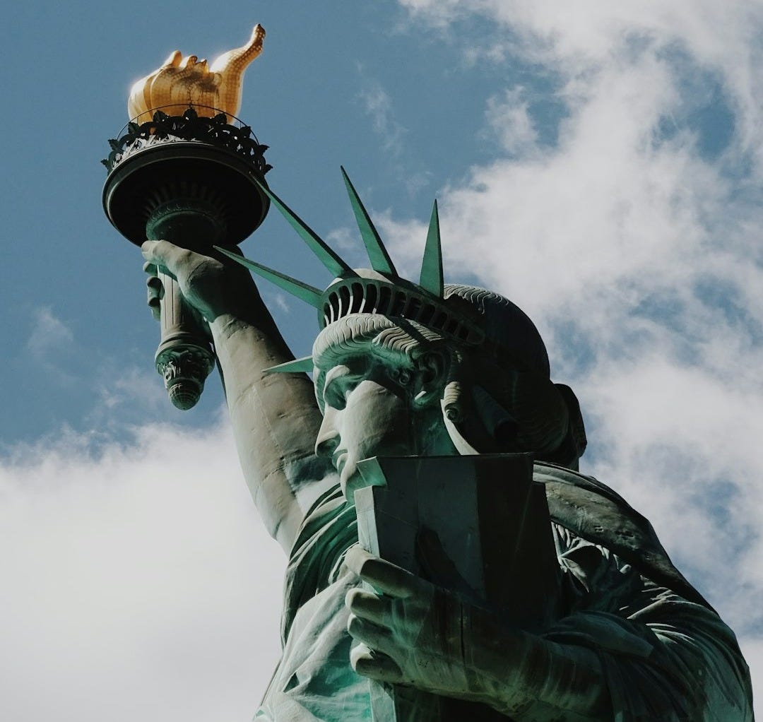 Statue of Liberty in New York City under blue and white skies