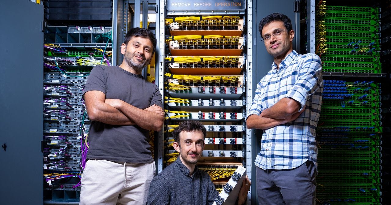 Amazon researchers in front of AWS resilient network graph racks Amazon researchers in front of AWS resilient network graph racks