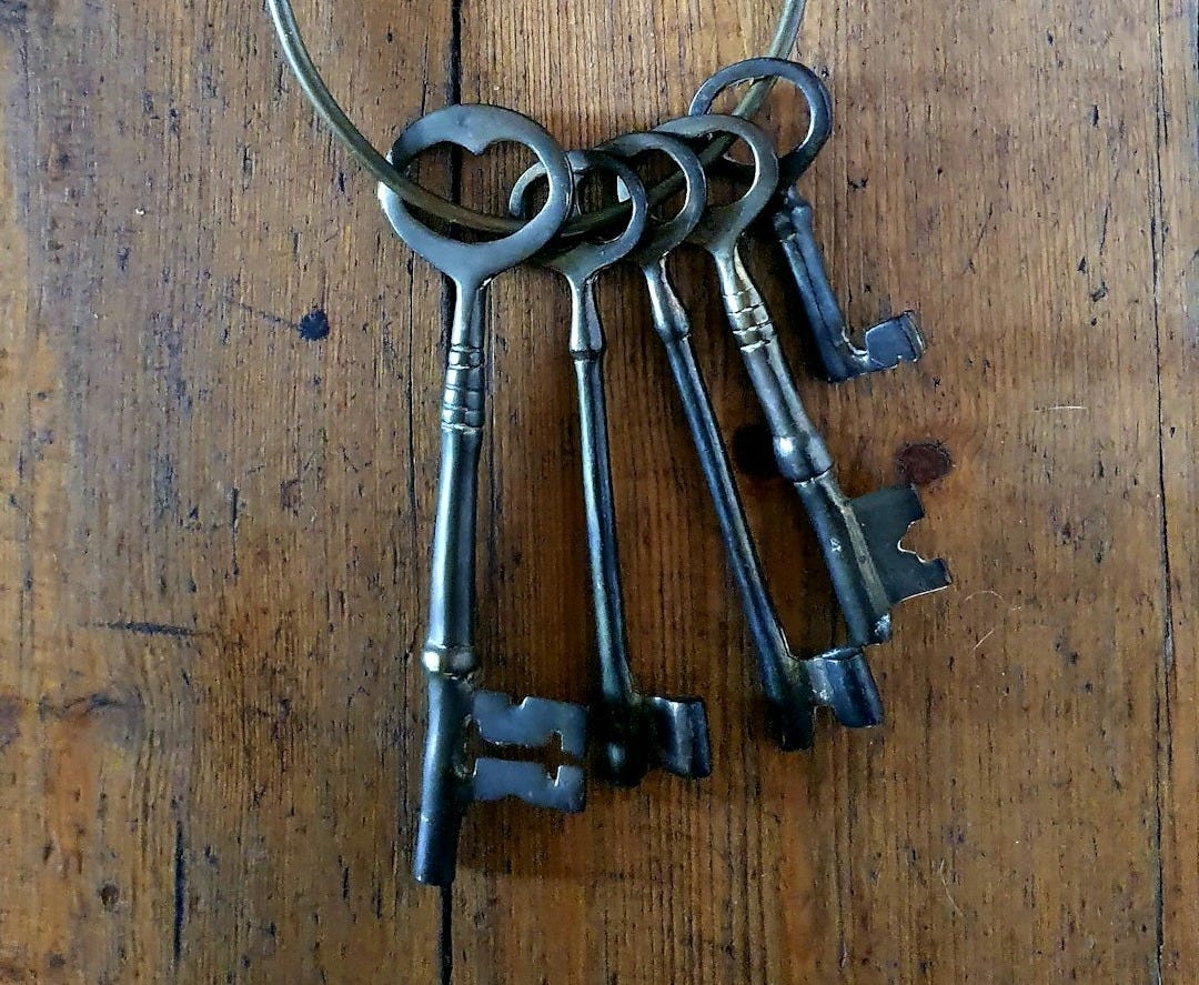 silver skeleton keys on brown wooden table