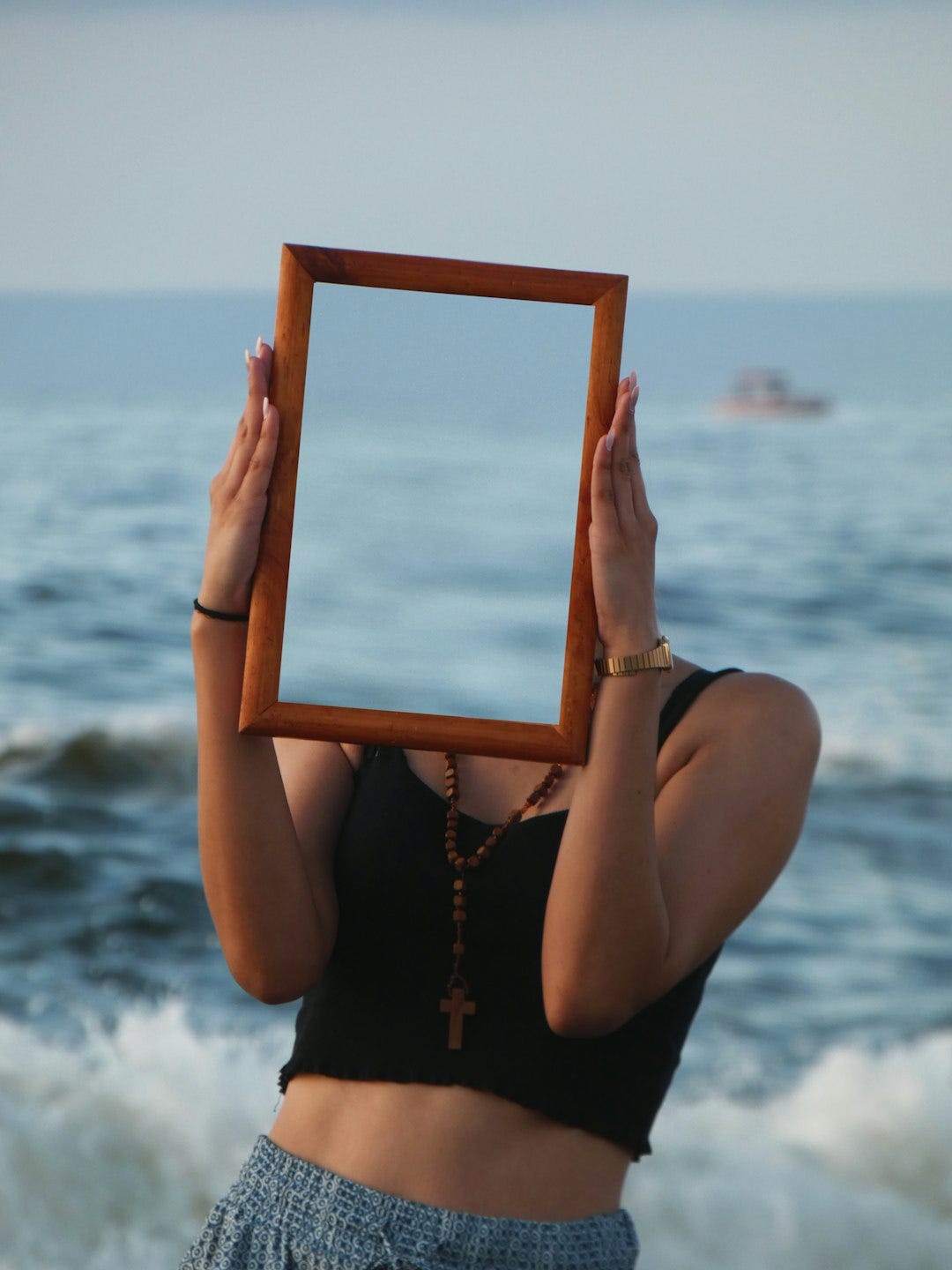 woman holding brown wooden photo frame woman holding brown wooden photo frame