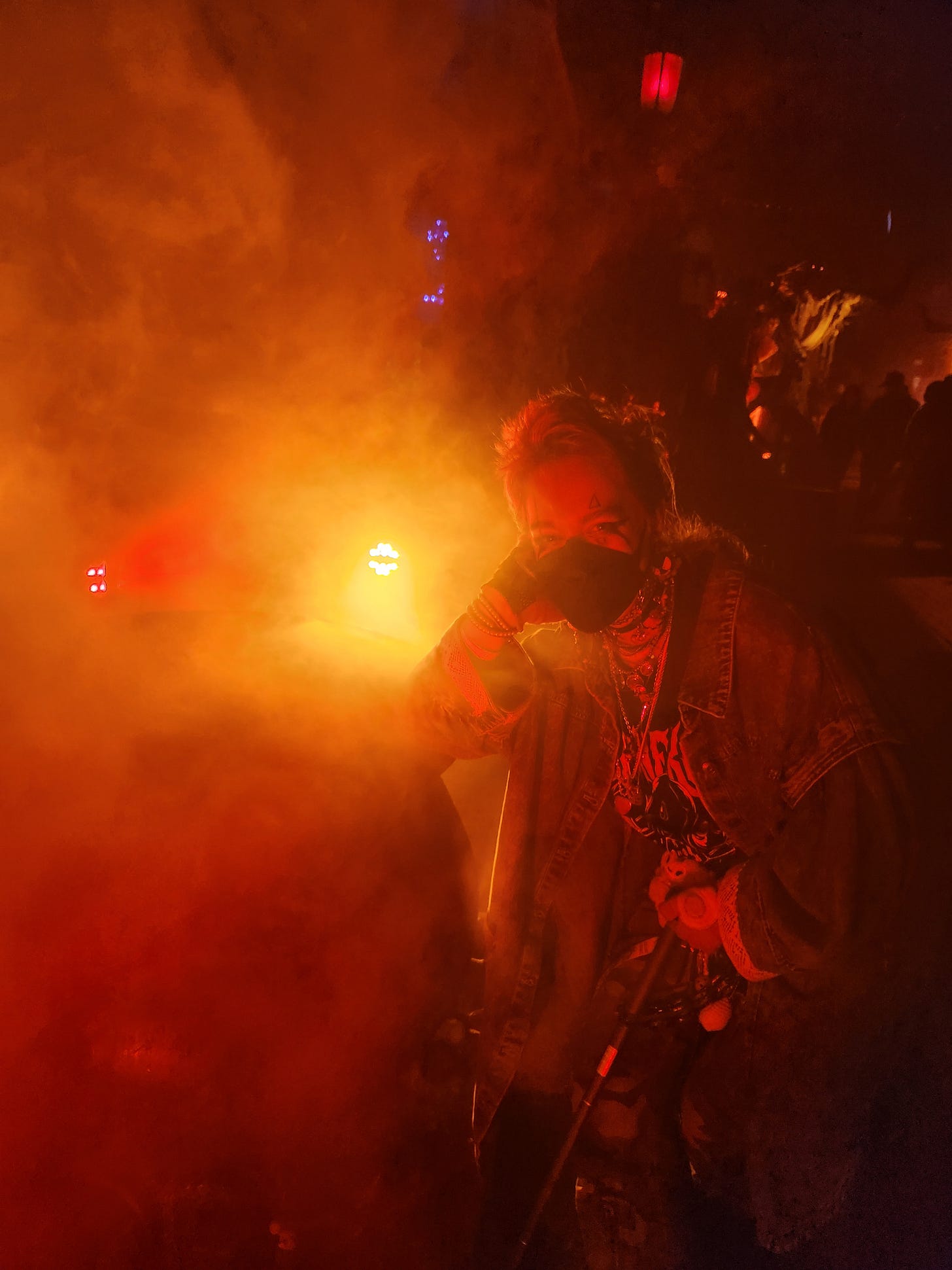 a photo of a person wearing a mask and heavy makeup
