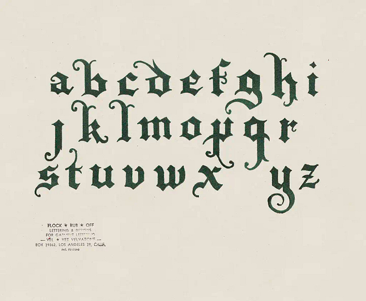 collection of velvet flocked alphabets on cream paper background