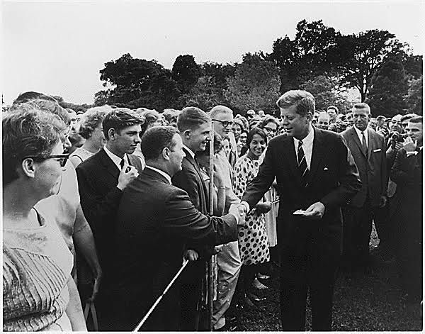 President Kennedy greets Peace Corps Volunteers.