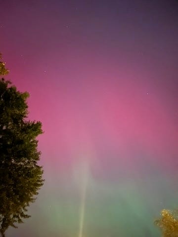 Linea driving and giving a peace sign, Linea presenting on a stage, Linea and her dad smiling and wearing sunglasses, the Northern Lights, Linea making a scared face next to her smiling dad at The House on the Rock, Linea and two friends in front of a hot air balloon.