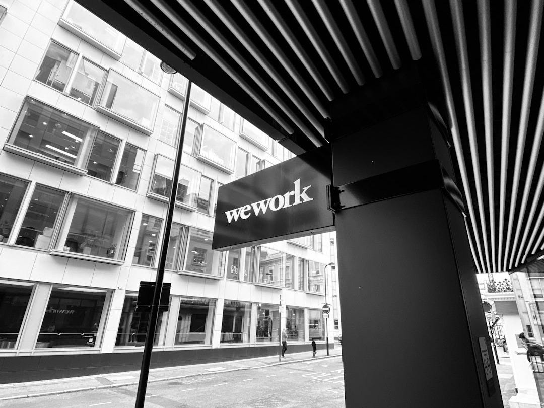 grayscale photography of wework signage grayscale photography of wework signage