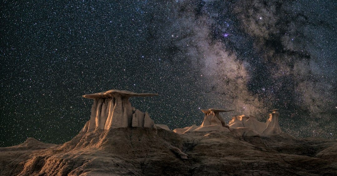 brown mountain under starry sky