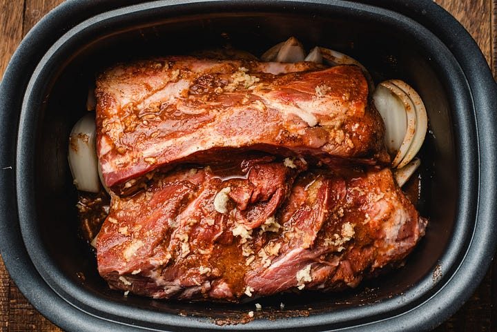 Left: Pork shoulder covered in seasonings and garlic in the slow cooker. Right: Slow cooked pulled pork with a fork pulling it apart.