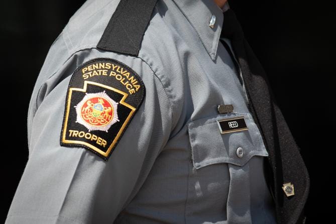 A Pennsylvania State Police Trooper patch on the uniform of a trooper. A Pennsylvania State Police Trooper patch on the uniform of a trooper.