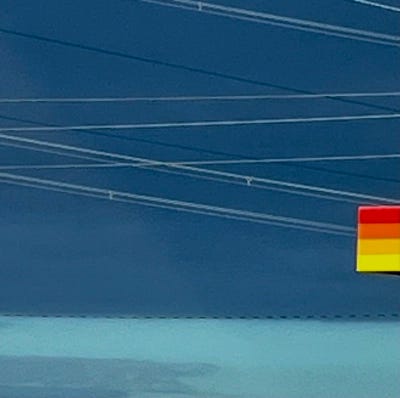 Heavy clouds align with an electric wire against a backdrop of dark blue sky.
