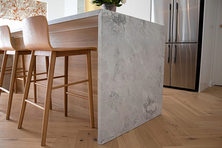 luxury resort-style kitchen in wood grain and super white quartzite designed by Plush Design Interiors and Penelope Herbert