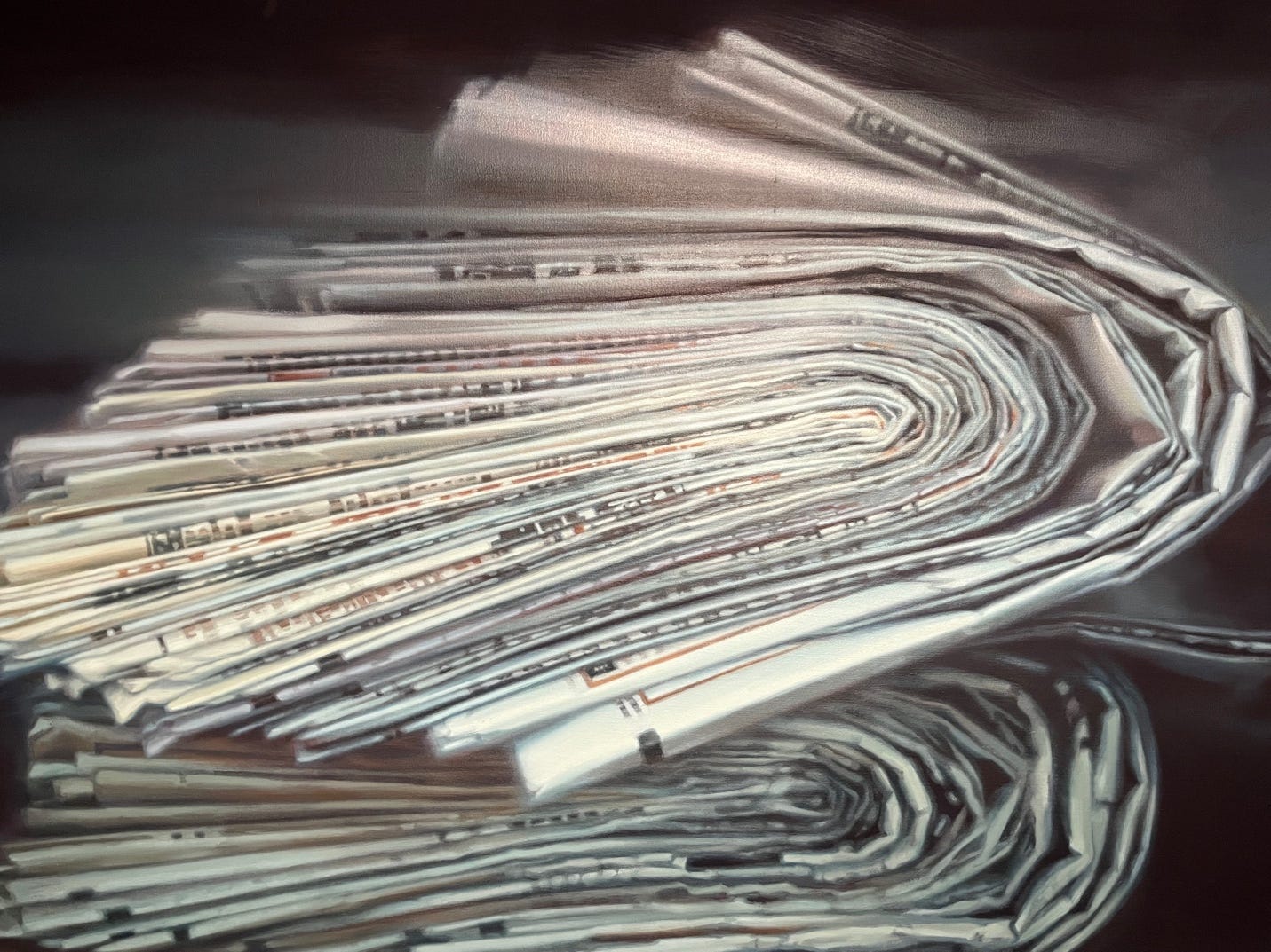 A close-up of a stack of newspapers

Description automatically generated