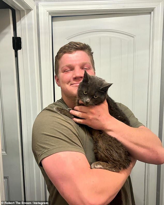 In his last social media post, Garrison  posed alongside a cat he had adopted