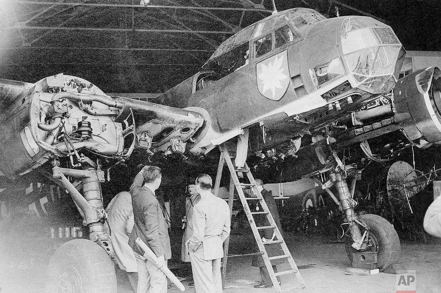 A German Junkers 88 bomber, brought down by the Royal Air Force, is meticulously examined by British experts on October 7, 1940, providing vital intelligence on enemy aircraft.