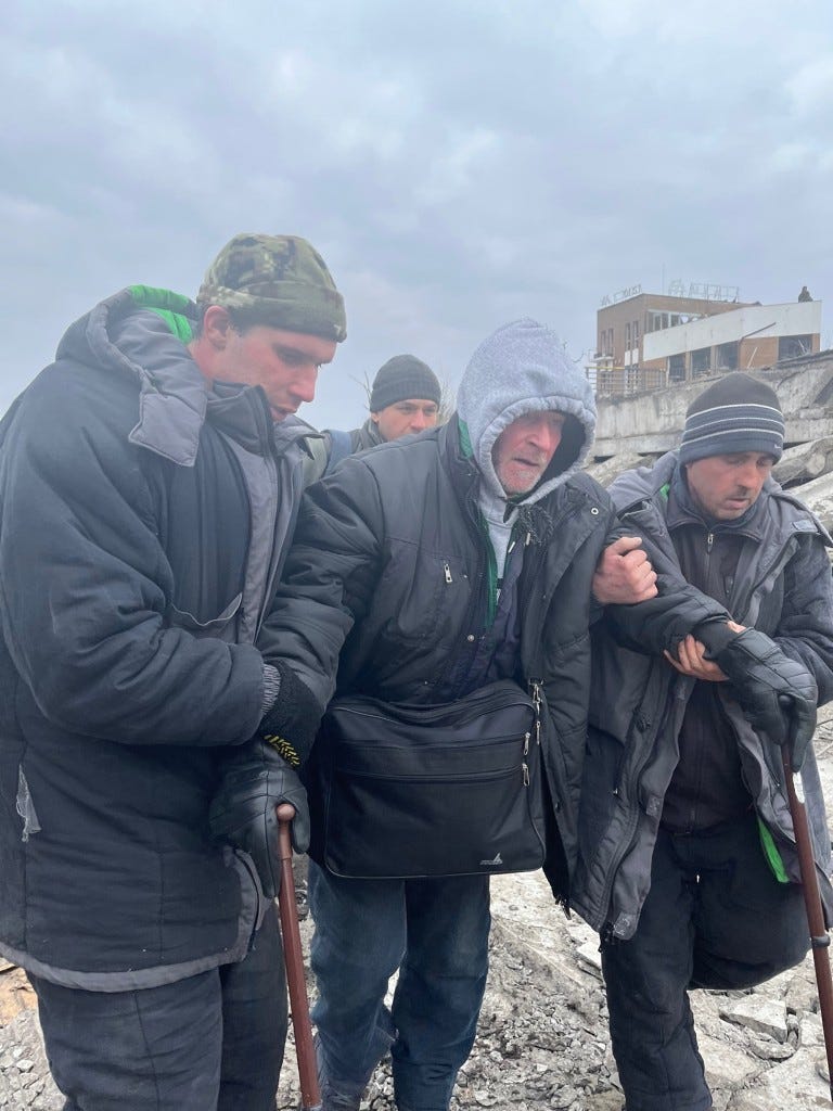 Civilians fleeing the town of Irpin on the edges of Kyiv late Monday morning