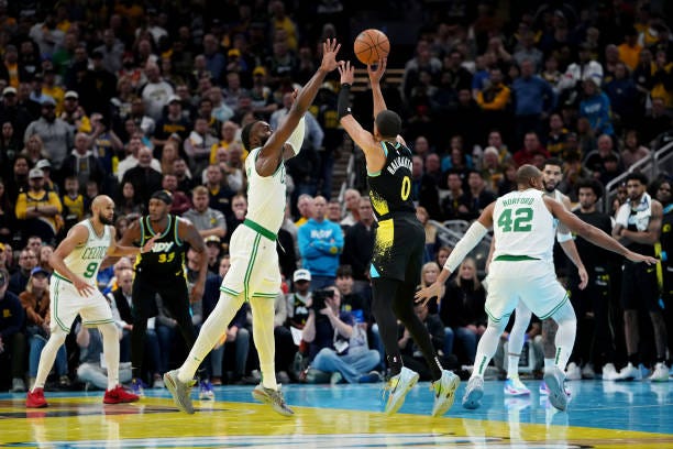 Tyrese Haliburton of the Indiana Pacers attempts a shot while being guarded by Jaylen Brown of the Boston Celtics in the fourth quarter during the...